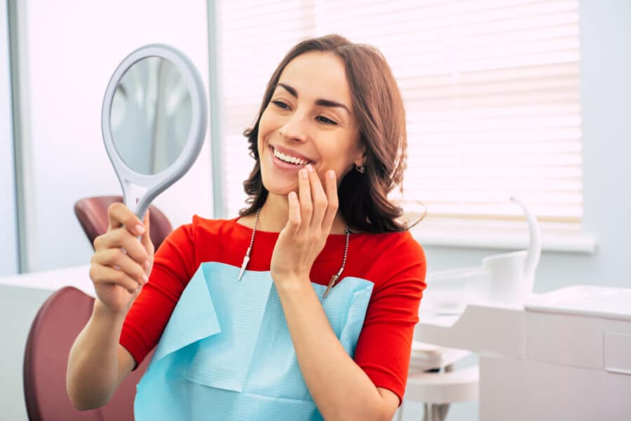 Woman with healthy smile after preventative dental treatment in Rapid City, SD