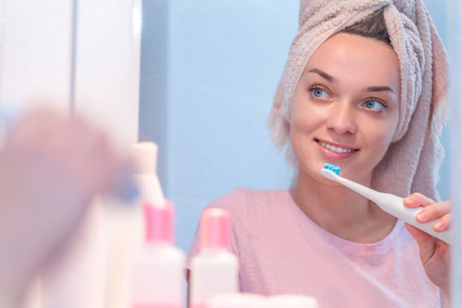 Woman brushing teeth in