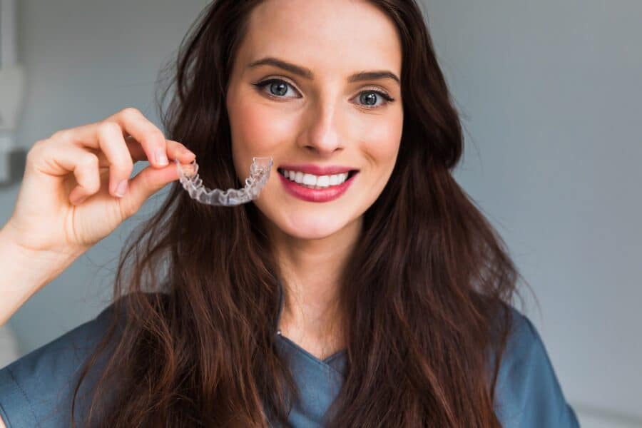 Woman with healthy smile after Invisalign treatment in Rapid City, SD