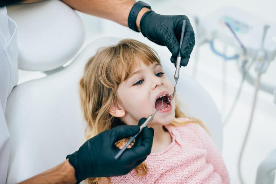 Child with healthy teeth after sealants in Rapid City, SD