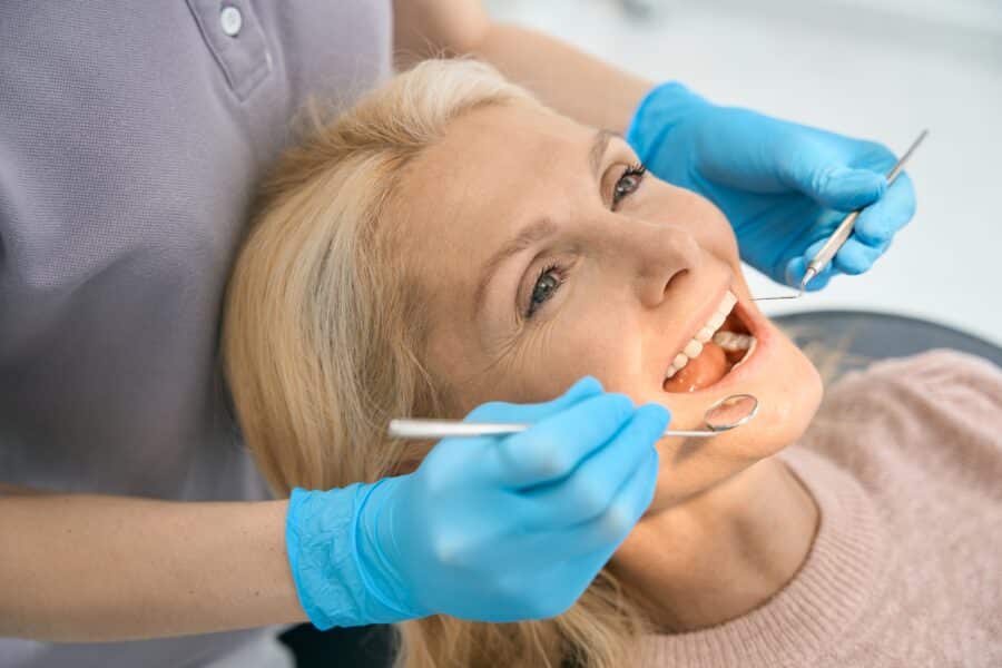 A dentist looking at a woman's dental implants in Spearfish, SD